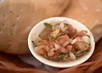 Pebre and bread is served on the table before the meal at most restaurants in Chile.