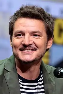 41-year-old man smiling at something to the left of the camera.