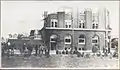 People in front of damaged building