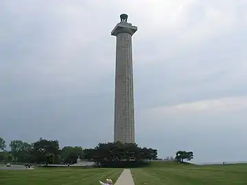 Doric column-shaped tower with trees at its base