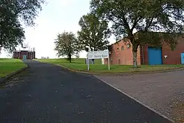 A made road leading uphill past two buildings