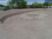 This was a Hohokam ballpark where they played ceremonial ball games. The villagers stood on top of the surrounding mound to observe the game.