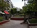 The historic Fokionos Negri Street, now pedestrianised with numerous cafés and a park along its length, runs through the middle of the district.