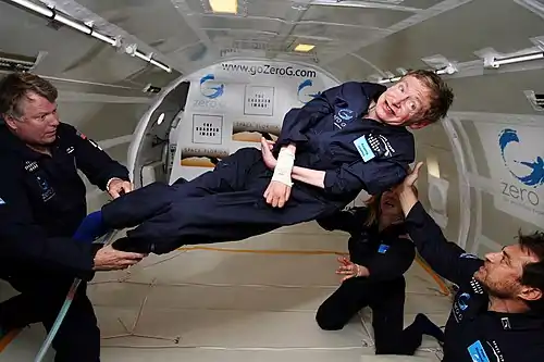 Physicist Stephen Hawking in an aircraft flying a parabolic trajectory to simulate zero gravity