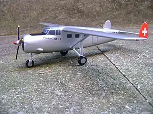 a single-engined aircraft with high wing and twin tails