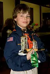 Image 9A happy Cub Scout holds a winning pine car