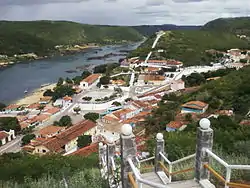 View of the centre of Piranhas looking upstream along the Rio São Francisco. The left-most building in the photo is a small part of the former railway station building (now a museum) and platform.