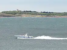 Small police boat on large body of water