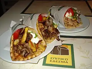 Gyros are a Greek dish of meat cooked on a vertical rotisserie