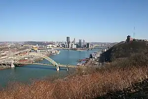 Daytime view from the West End Overlook, with the West End Bridge in the foreground and the downtown skyline in the background.