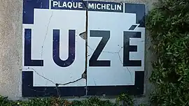 An old Michelin name board, entering Luzé