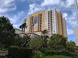 The Platinum, a 17-story hotel and condominium building, yellow and white in color.