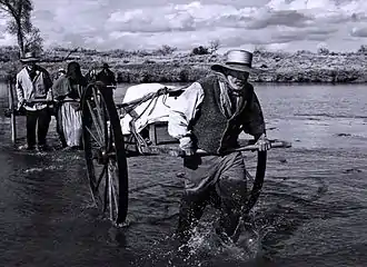 Mormon handcart pioneers crossing the Platte River, modern reenactment of 1856 expedition