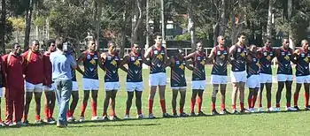 The Papua New Guinea Mosquitos line up for the national anthem before taking on the Peace Team