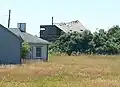 Storm-damaged former fire control tower resembling a beach cottage, former Fort Greene south reservation