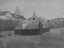 A man standing in front of an armored car