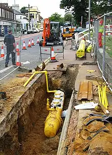 Image 97Polyethylene plastic main being placed in a trench (from Natural gas)