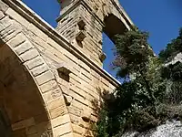 Stonework on the Pont du Gard, showing the protruding blocks that were used to support the scaffolding