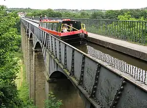 A narrowboat traverses the Pontcysyllte Aqueduct.