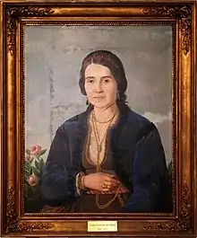 Oil painting depicting a bejweled middle-aged lady facing the onlooker