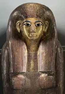 Gilded and incised coffin lid with inlaid eyes and eyebrows