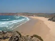 Praia do Amado, with the Pontal cliffs in the distance