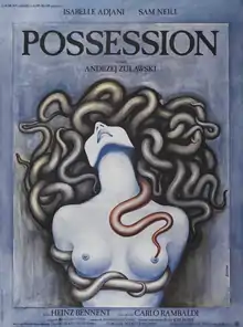 On a slate gray background, a naked woman is seen from the waist up. Tentacles replace her hair, tie her hands behind her back, and run under her breasts.