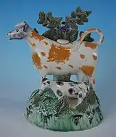 Prattware cow and calf bocage figure, underglaze colours, circa 1800