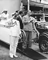 President Franklin D. Roosevelt and his Naval Aide, Captain Daniel J. Callaghan, taking the salute of a composite battalion of the 14th Infantry at Gatun Locks as they were disembarking from USS Tuscaloosa. February 18, 1940