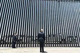 President Trump in front of "The Wall" at the Arizona–Mexico border.(Craighead, 2020)