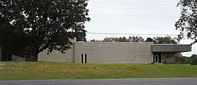 A one-story office building with a small entrance area and mostly blank front wall