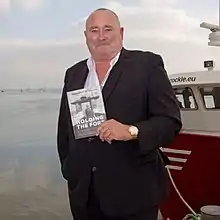 Bates in 2015 posing with his book