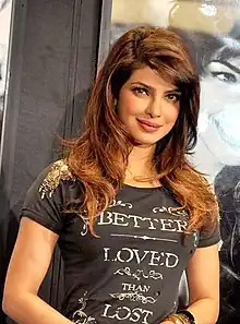 A photograph of Priyanka Chopra looking forward, smiling and posing for the camera