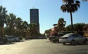 View across a parking lot of the tallest of the three towers