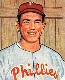 A baseball card image of a smiling man wearing a red baseball cap and a gray baseball jersey with "Phillies" across the chest in red script