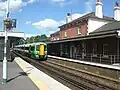 Station buildings with a Portsmouth-bound train arriving at Platform 2 in the foreground.