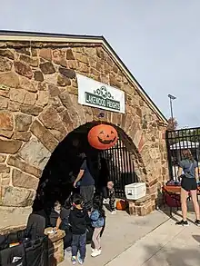 a large orange paper jack o'lantern decorating a neighborhood Halloween party