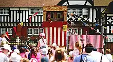 A Punch and Judy show on the village green