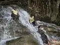 Local swimmers and waterfall at entrance