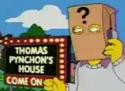 Cartoon frame showing a man with a paper bag over his head talking into a mobile phone. The bag has a large question mark printed on it and the man stands in front of a large illuminated sign in block letters which says 'THOMAS PYNCHON'S HOUSE – COME ON IN'