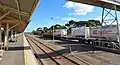 Aurizon ex-Westrail Q class locomotive no Q4019, in ARG livery, runs through Kalgoorlie railway station West Kalgoorlie yard and the Cockburn Cement depot in Parkeston, Western Australia.