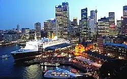 The QE2 docked at Sydney Harbour, looking towards Circular Quay and the Sydney CBD.