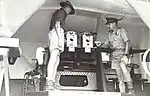 Officers inspect breeches of twin 6pdr gun. 1943.