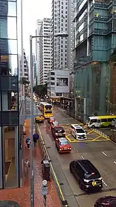 Western end of Queen's Road East on a rainy day, viewed from the overpass. Three Pacific Place is on the right. Hopewell Centre is visible in the distance.