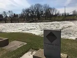 Rapids on Wapsipinicon River with old mill monument at Quasqueton