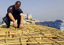 Image 48A sailor from HMAS Adelaide inspecting a ship in the Persian Gulf during 2004 (from History of the Royal Australian Navy)