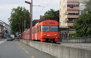 Red train at canopy-covered platform