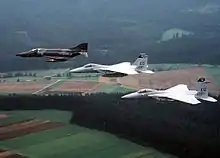 An RF-4E Phantom II of AG 51 and two U.S. Air Force F-15A Eagles in flight over Germany