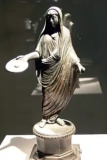 Image 2A Roman priest, his head ritually covered with a fold of his toga, extends a patera in a gesture of libation (2nd–3rd century) (from Roman Empire)