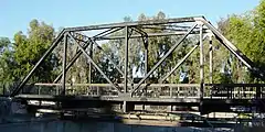 Truss bridge of the Southern Pacific Railroad in California for a single track railway, converted to pedestrian use and pipeline support.